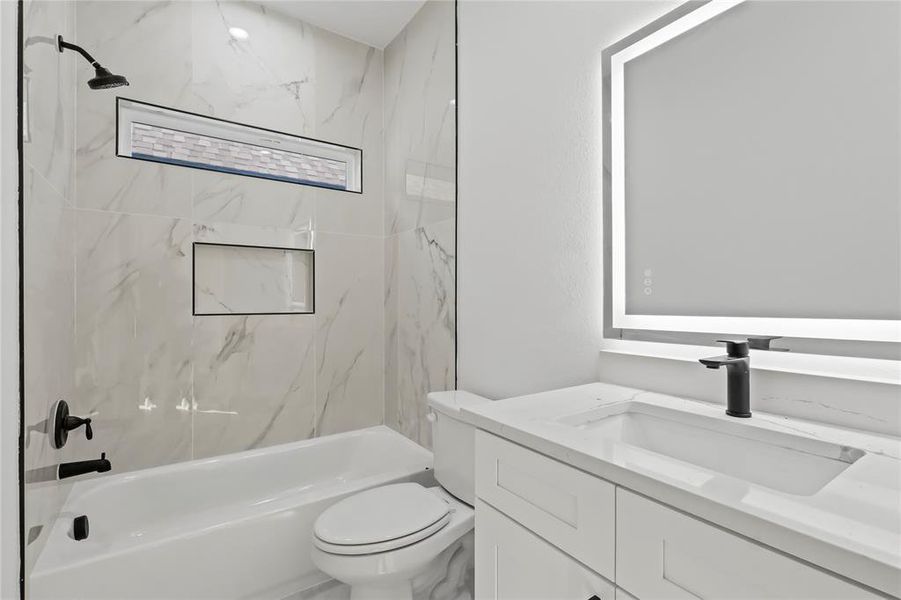 Full bath featuring vanity and shower / bath combination