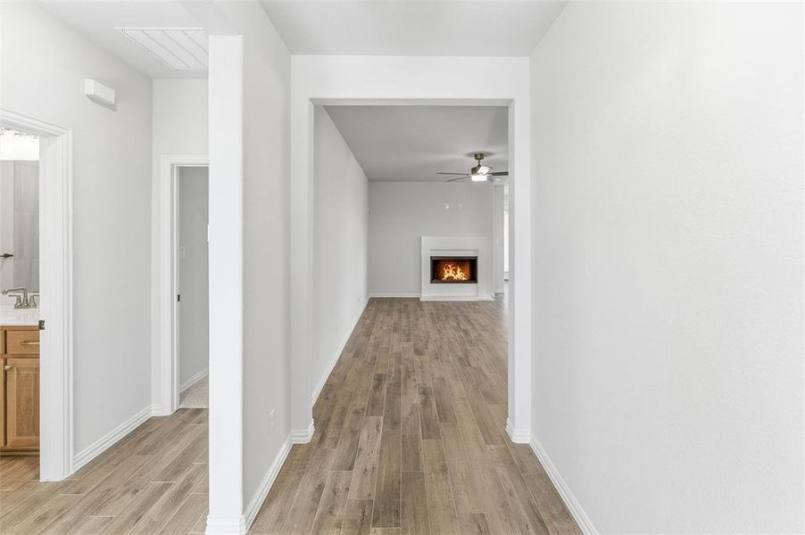 Corridor featuring light wood-style flooring