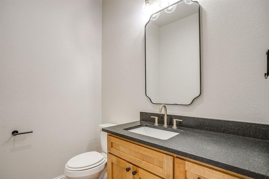 Bathroom with a textured wall and vanity Bathroom with a textured wall and vanity