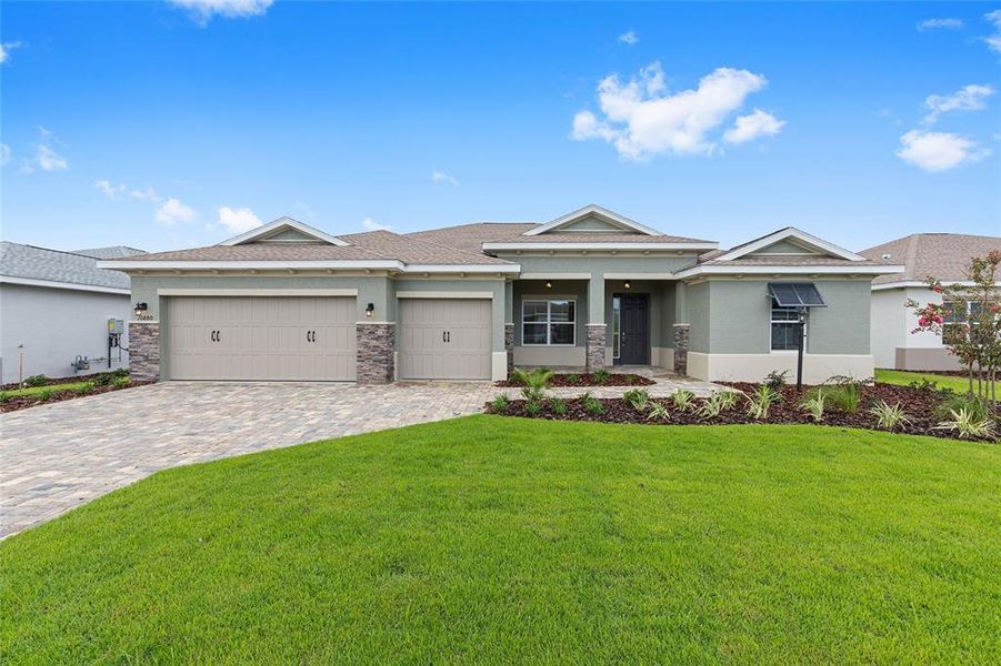 Front exterior of a new home in On Top of the World Communities, Ocala, FL, highlighting curb appeal (Image 1).