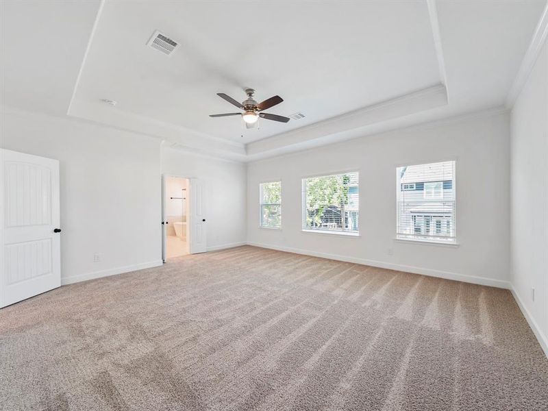 A spacious and well-lit Primary Bedroom with access to a luxurious bathroom and large closet.  (Sample photos of a completed Warwick floor plan. The image may feature alternative selections and/or upgrades.)