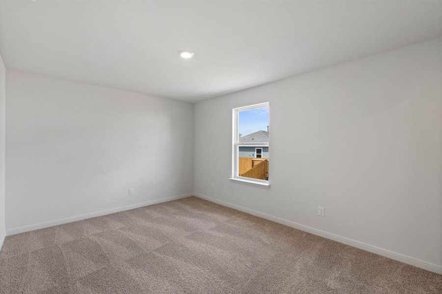Unfurnished room featuring baseboards and light colored carpet