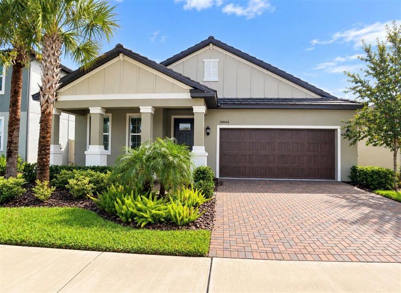 Front exterior of a new home in Angeline Active Adult, Land O' Lakes, FL, highlighting curb appeal (Image 26).