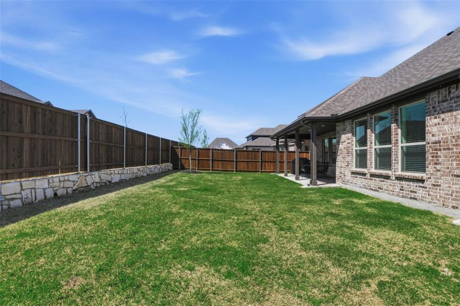 Exterior details and patio area of a home in Whitewing Trails, Princeton (Image 26).