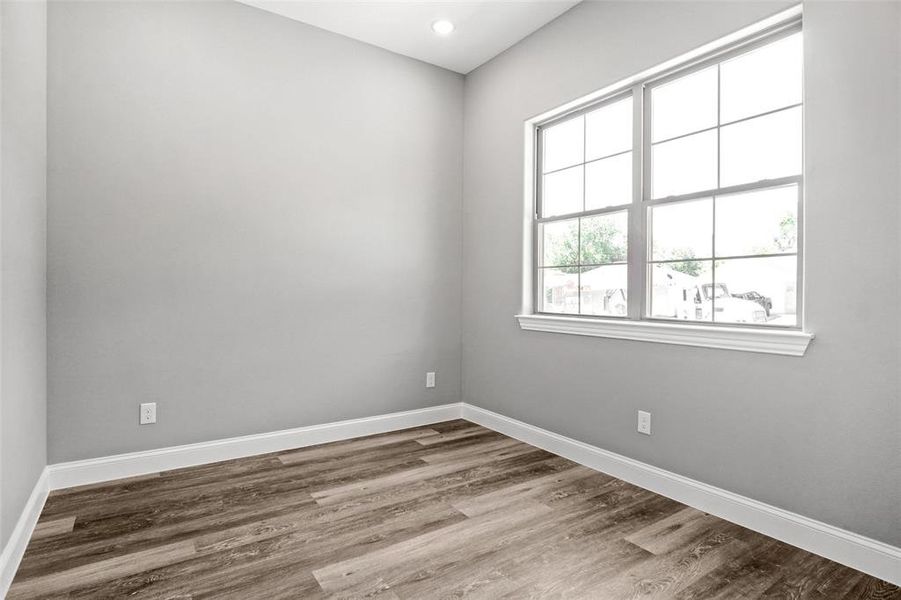 Unfurnished room with wood finished floors and recessed lighting Unfurnished room with wood finished floors and recessed lighting