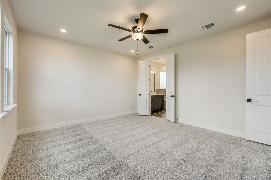 French doors lead you from the primary bedroom into the spa-like large bathroom.