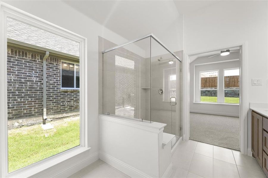 Bathroom featuring a healthy amount of sunlight, tile flooring, and vanity