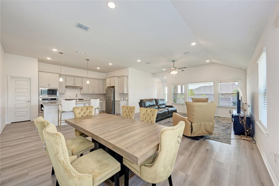 An open concept design seamlessly blends the kitchen, dining, and living areas for modern living.
