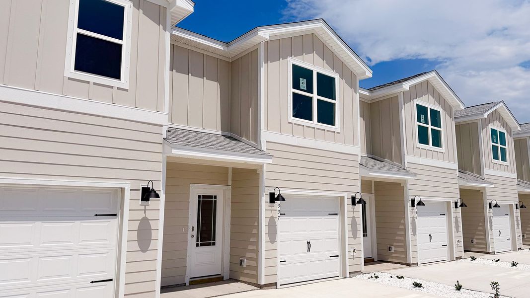 Front exterior of a new home in WindMark Beach, Port Saint Joe, FL, highlighting curb appeal (Image 19).