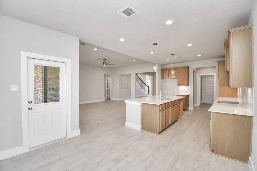 View from the breakfast area to the kitchen and living room. Sample photo of completed home with similar floor plan. Actual colors and selections may vary. View from the breakfast area to the kitchen and living room. Sample photo of completed home with similar floor plan. Actual colors and selections may vary.