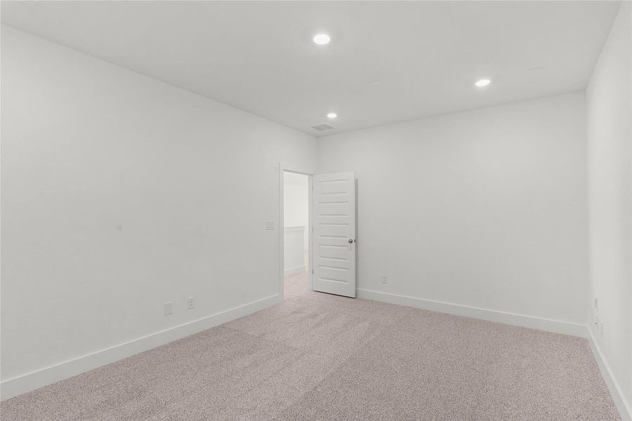 Unfurnished room featuring recessed lighting and light carpet