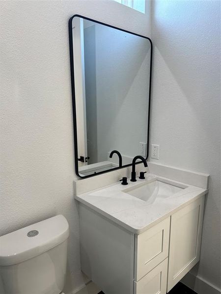 Bathroom featuring vanity and toilet