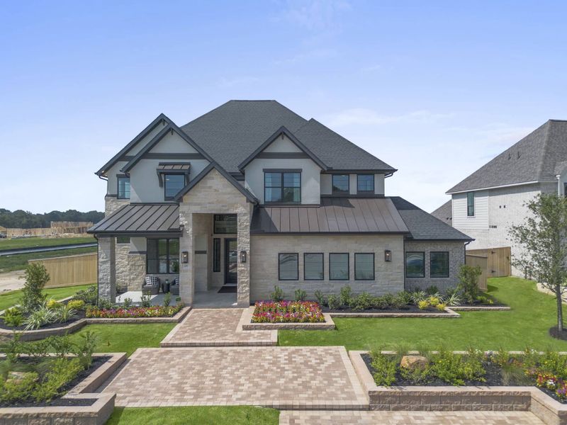 Front exterior of a new home in Evergreen, Conroe, TX, highlighting curb appeal (Image 24). Front exterior of a new home in Evergreen, Conroe, TX, highlighting curb appeal (Image 24).