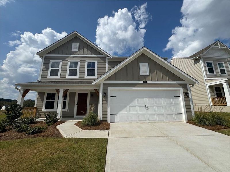 Front exterior of a new home in Twin Lakes, Hoschton, GA, highlighting curb appeal (Image 1).