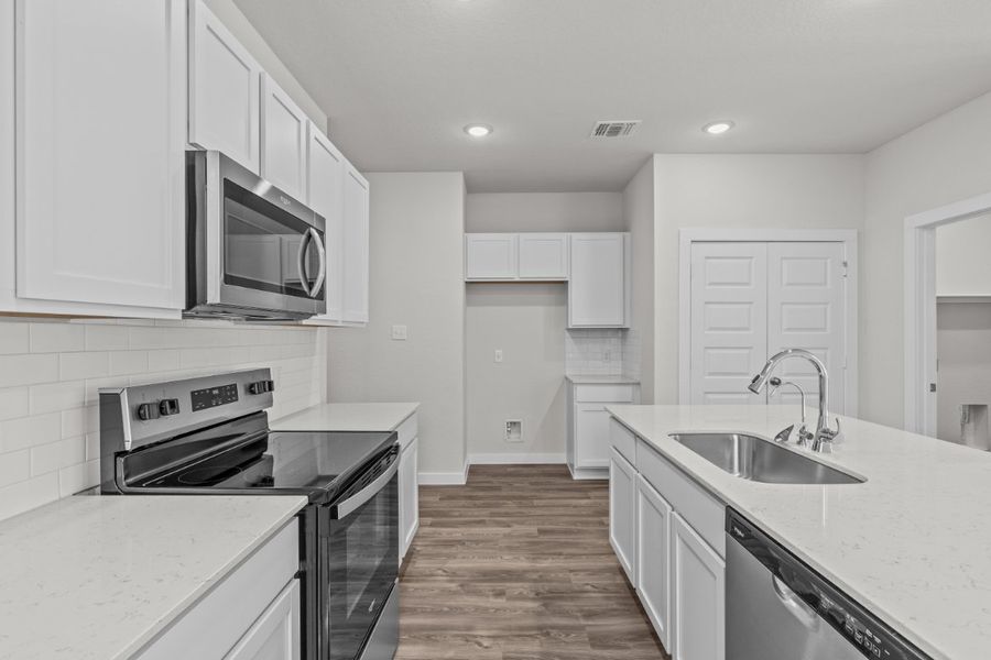 A kitchen with white cabinets. A kitchen with white cabinets.