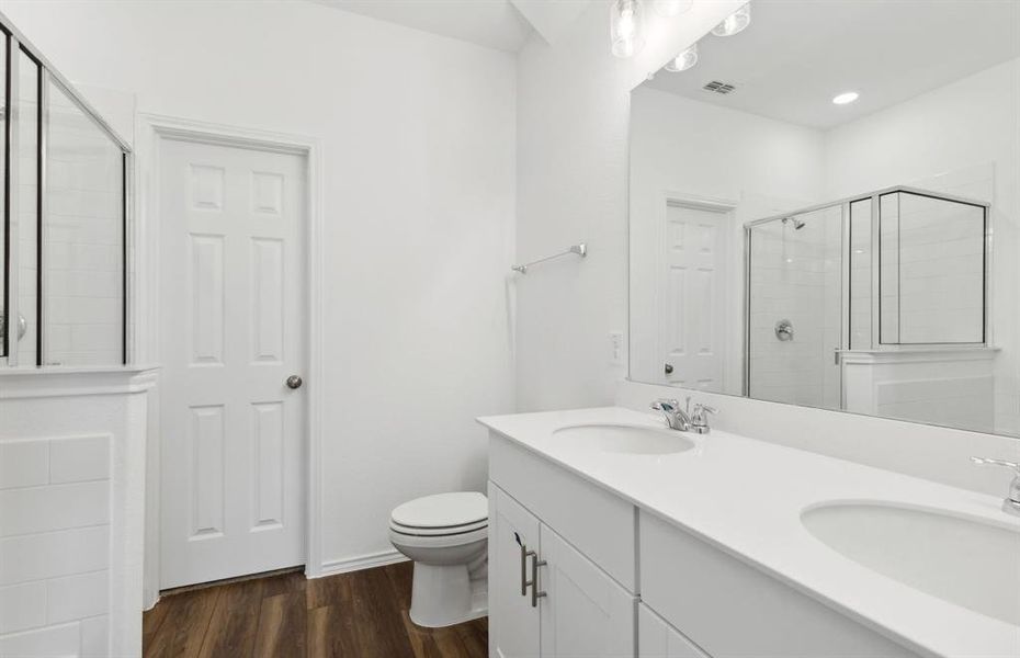 Spacious owner's suite with dual vanity *real home pictured