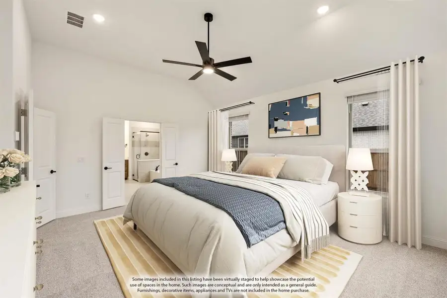 Spacious master bedroom with vaulted ceiling, ceiling fan, carpet flooring, and ensuite bathroom doorway visible. Spacious master bedroom with vaulted ceiling, ceiling fan, carpet flooring, and ensuite bathroom doorway visible.