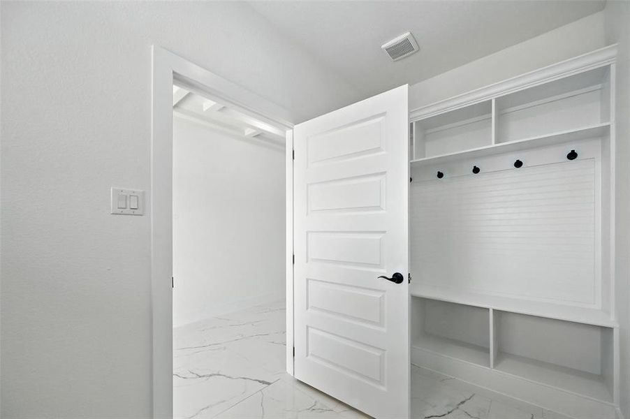 Mudroom with light marble finish flooring