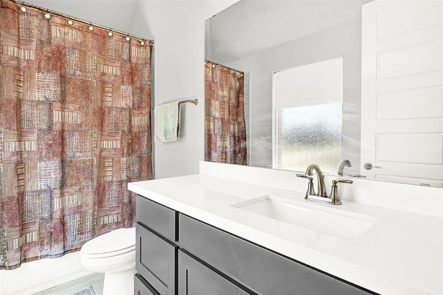 Full bathroom featuring vanity and shower / bath combination with curtain Full bathroom featuring vanity and shower / bath combination with curtain