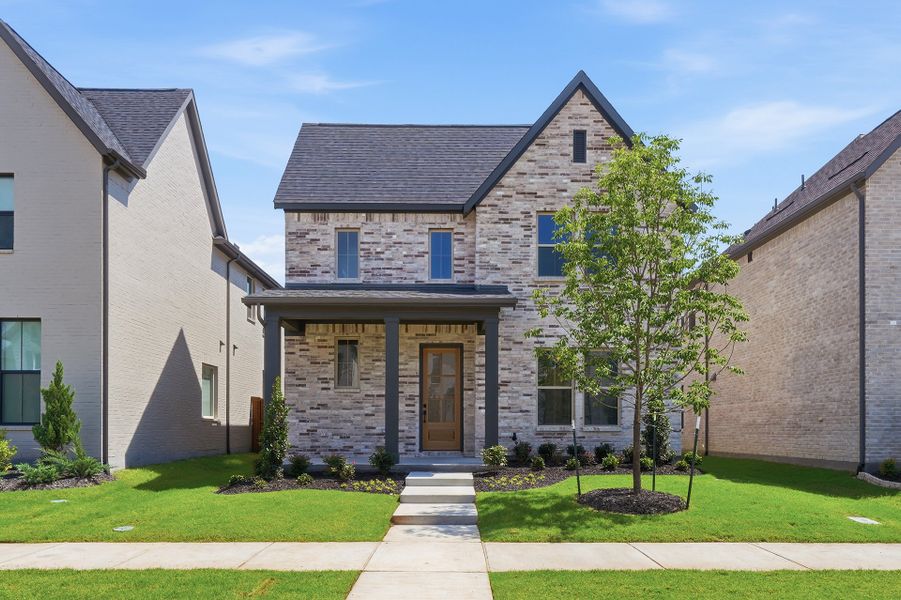 Front exterior of a new home in Light Farms Brenham - 40' Lots, Celina, TX, highlighting curb appeal (Image 1). Front exterior of a new home in Light Farms Brenham - 40' Lots, Celina, TX, highlighting curb appeal (Image 1).