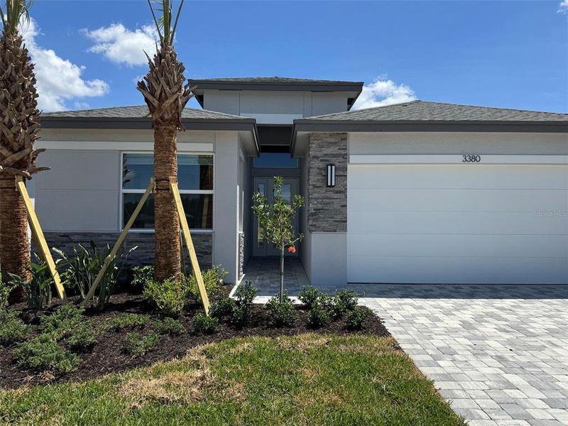 Front exterior of a new home in Valencia Ridge (55+), Wesley Chapel, FL, highlighting curb appeal (Image 17).