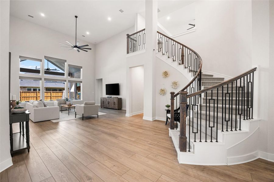 The impressive grand staircase creates a stunning focal point, leading to the second floor with elegance and timeless style.
