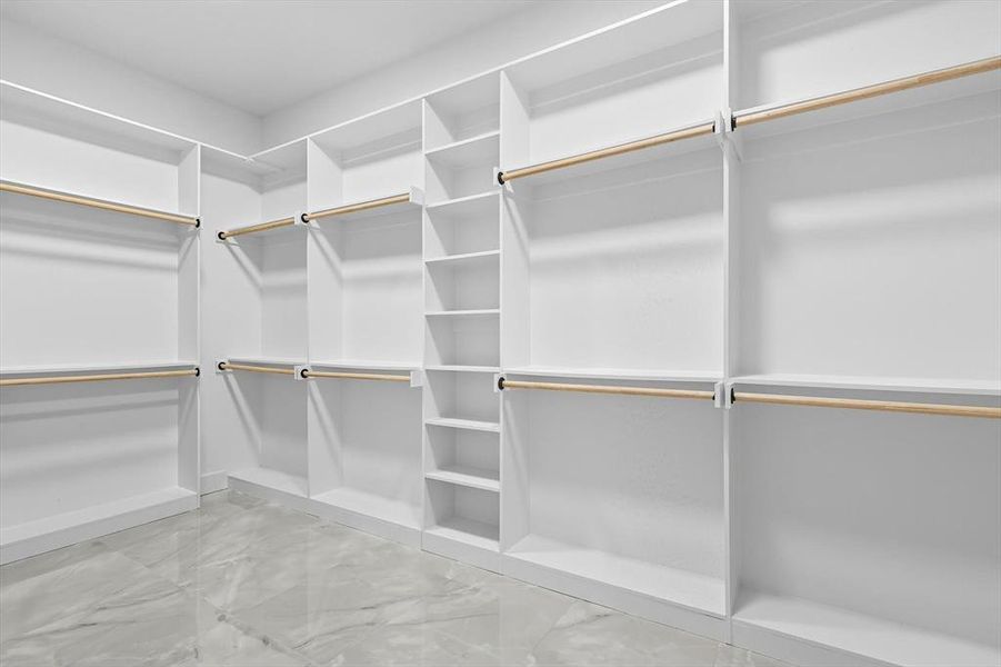 Spacious closet featuring light marble finish floors Spacious closet featuring light marble finish floors