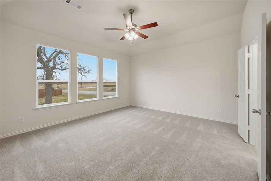 Unfurnished room featuring light colored carpet and ceiling fan
