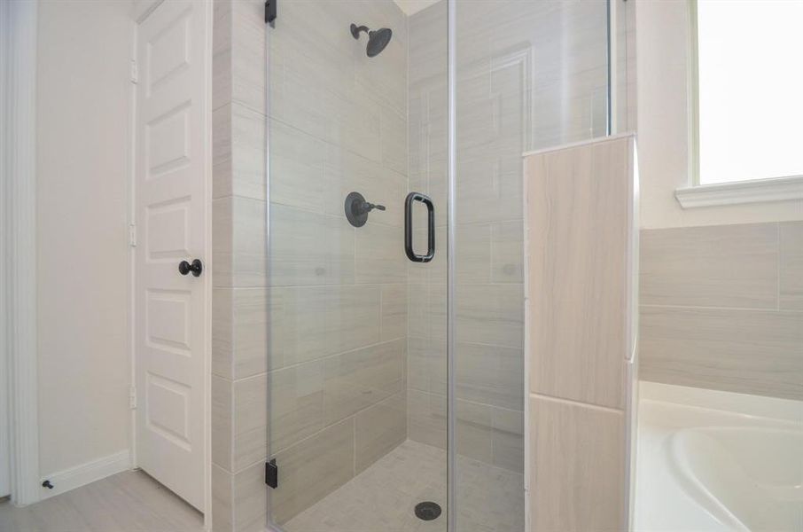 The walk-in shower offers a refreshing escape, featuring modern fixtures and sleek glass doors. This spacious design provides a seamless shower experience, perfect for relaxing after a long day.