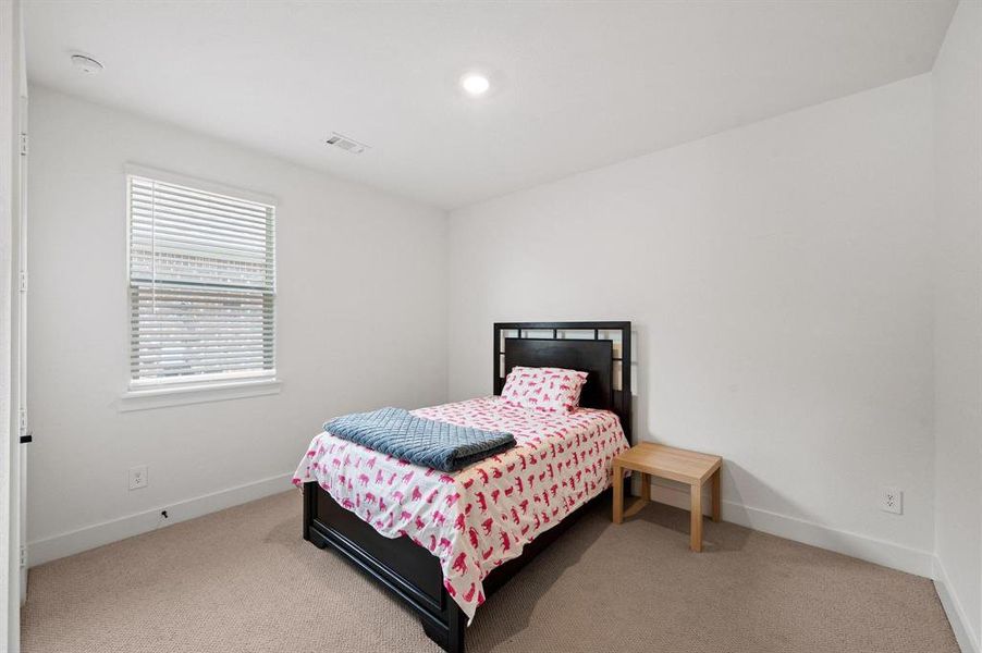Room featuring a window with blinds, recessed lighting, and light neutral carpeting Room featuring a window with blinds, recessed lighting, and light neutral carpeting