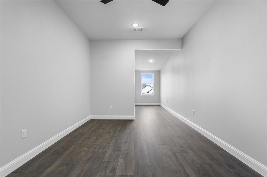 Empty room featuring dark hardwood / wood-style floors