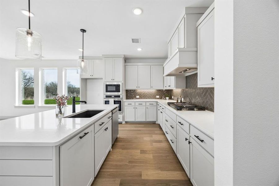 Featuring beautiful flooring, clean crisp white cabinets, lovely counter tops and complimentary backsplash, this dream kitchen is one for the ages! Featuring beautiful flooring, clean crisp white cabinets, lovely counter tops and complimentary backsplash, this dream kitchen is one for the ages!