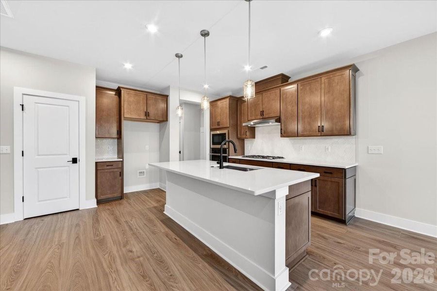 Gourmet kitchen with arm brown cabinets