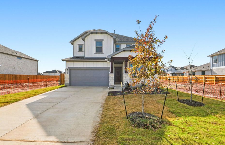 Front exterior of a new home in Santa Rita Ranch, Liberty Hill, TX, highlighting curb appeal (Image 23). Front exterior of a new home in Santa Rita Ranch, Liberty Hill, TX, highlighting curb appeal (Image 23).