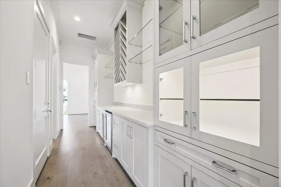 Butler's pantry with wine storage, glass front cabinetry and fridge enhance your dining and entertaining experience. Butler's pantry with wine storage, glass front cabinetry and fridge enhance your dining and entertaining experience.