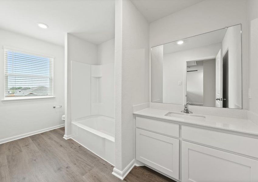 The secondary bathroom of the Cypress has a large vanity and a shower-tub combo.