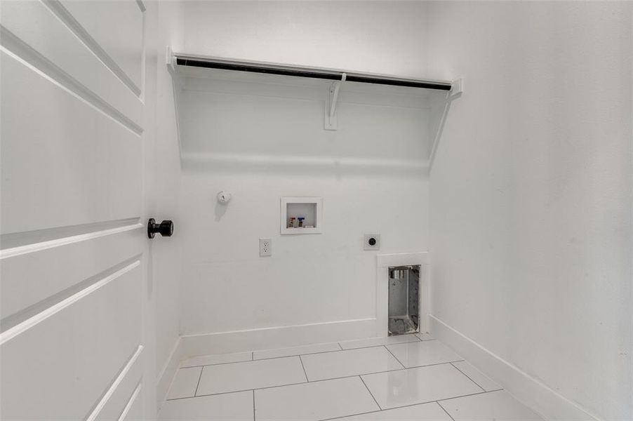 Washroom featuring tile patterned floors, electric dryer hookup, hookup for a washing machine, and hookup for a gas dryer