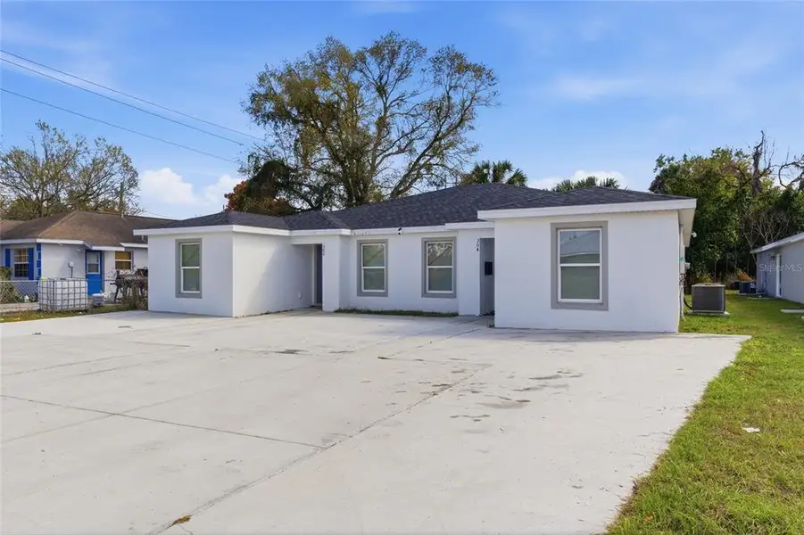 Front exterior of a new home in , Winter Haven, FL, highlighting curb appeal (Image 1). Front exterior of a new home in , Winter Haven, FL, highlighting curb appeal (Image 1).