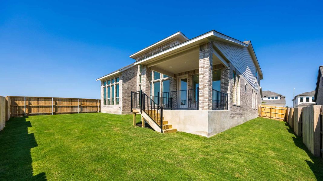 Rear view of house featuring brick siding, a fenced backyard, a patio area, and stairs Rear view of house featuring brick siding, a fenced backyard, a patio area, and stairs