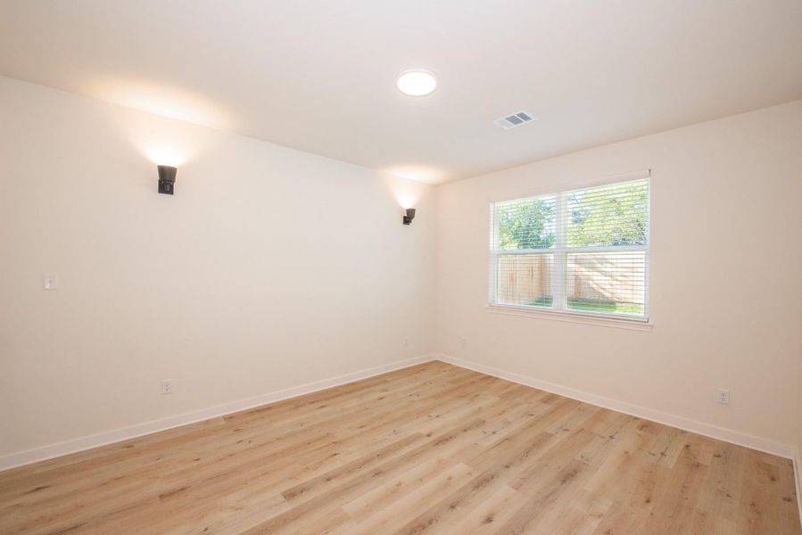 Unfurnished room with light wood-type flooring and baseboards