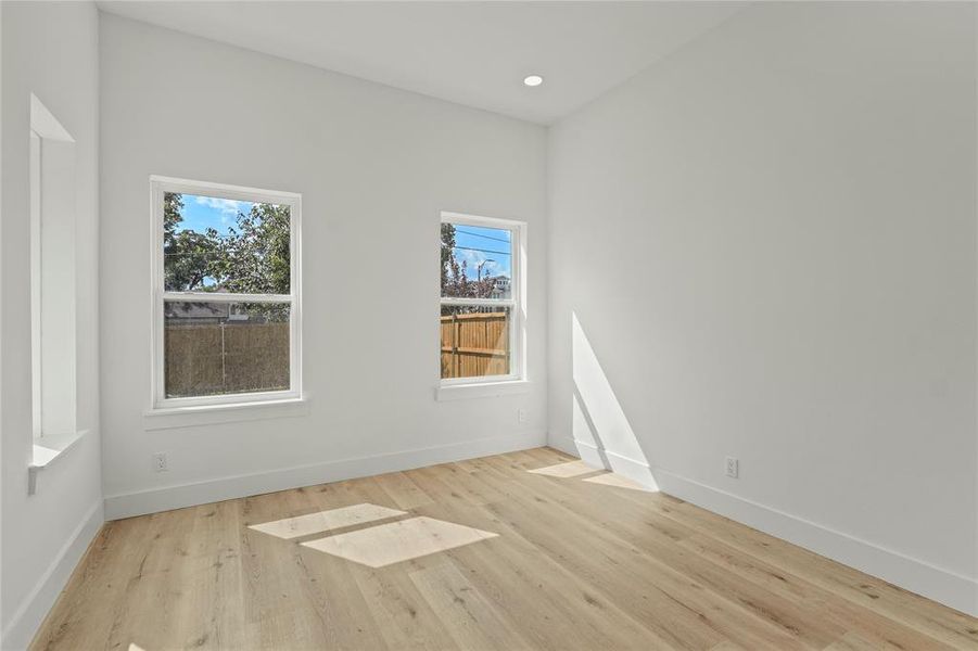 Unfurnished room featuring light wood-type flooring and recessed lighting Unfurnished room featuring light wood-type flooring and recessed lighting