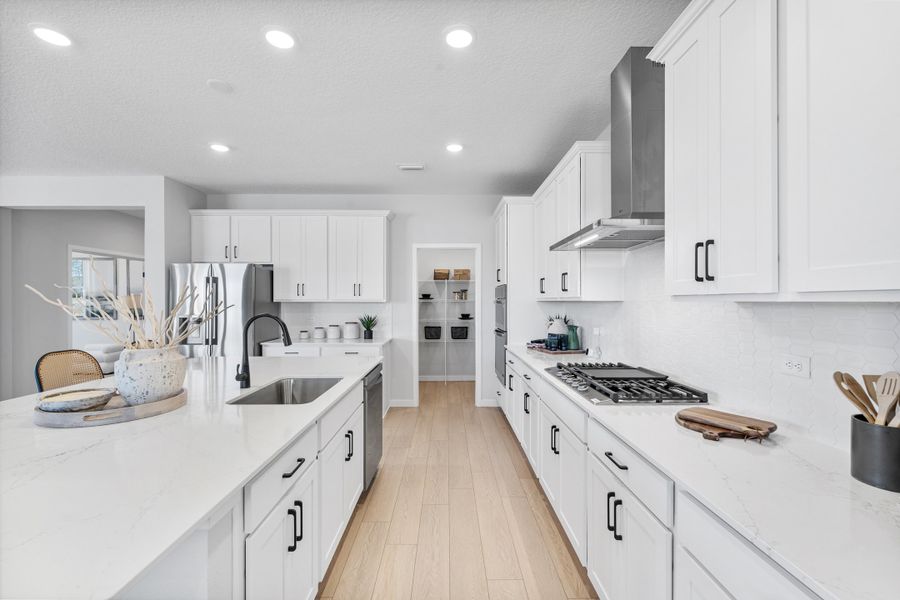 Kenai Model Home Chef's Kitchen with Walk-In Pantry at Reserve East