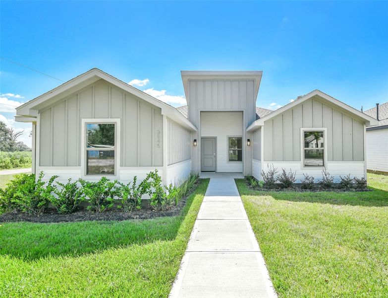 Modern farmhouse-style exterior with clean lines, fresh landscaping and inviting curb appeal.