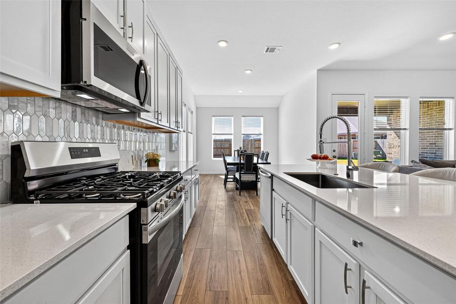 Modern chef’s kitchen with stainless steel appliances, sleek countertops, and ample space for culinary creativity. Modern chef’s kitchen with stainless steel appliances, sleek countertops, and ample space for culinary creativity.