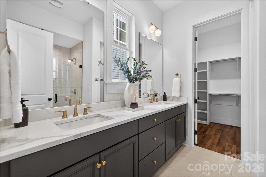 Beautiful primary bath offers dual vanity, abundant storage and large zero entry tile shower. Beautiful primary bath offers dual vanity, abundant storage and large zero entry tile shower.