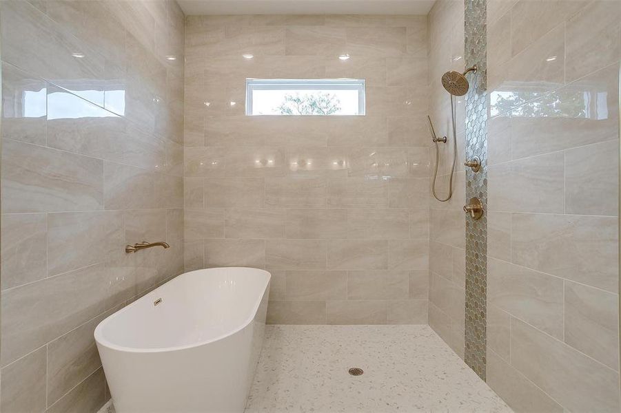 Bathroom featuring tile walls and a tile shower