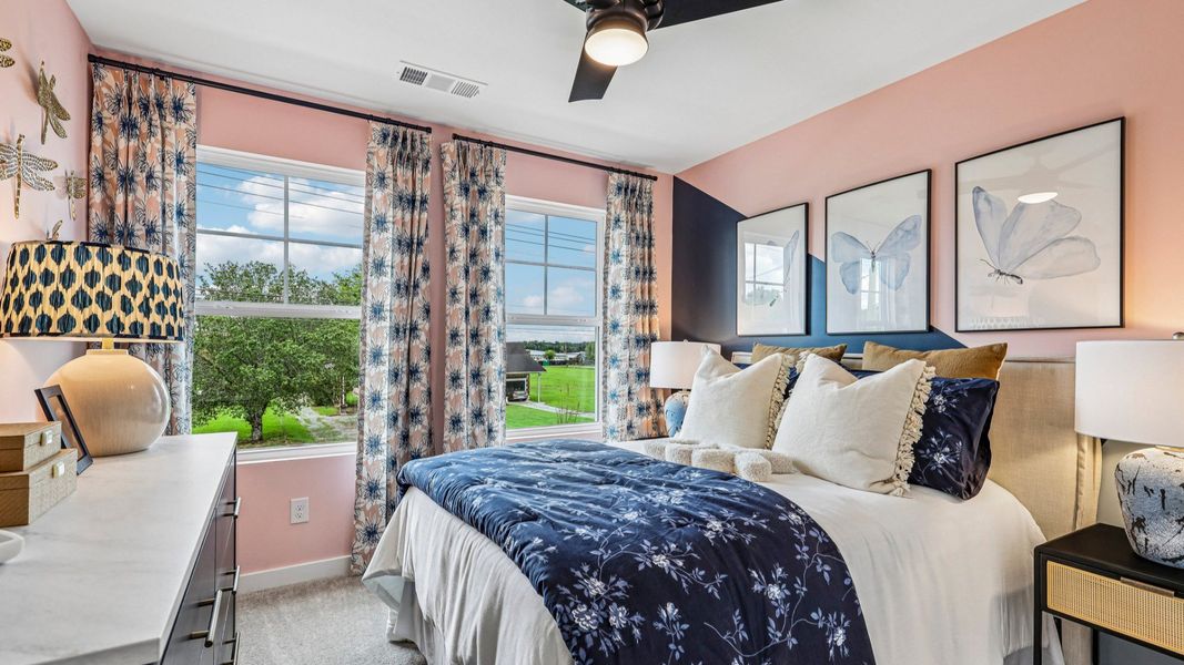 Secondary bedroom with carpet and windows