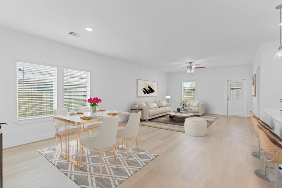 The open family area connects seamlessly to the outdoor space, with large windows bringing in natural light and offering a beautiful view of the backyard.  Virtual staged