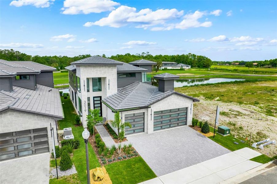 Front exterior of a new home in Hampton Green at Providence, Davenport, FL, highlighting curb appeal (Image 29).