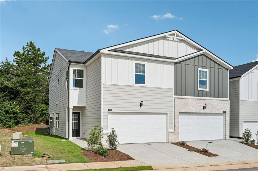 Front exterior of a new home in Artisan Walk, Fairburn, GA, highlighting curb appeal (Image 1). Front exterior of a new home in Artisan Walk, Fairburn, GA, highlighting curb appeal (Image 1).